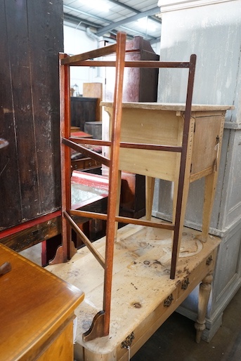 A George III style yew serpentine toilet mirror, height 64cm, together with a Victorian folding towel rail and a mahogany tripod wine table